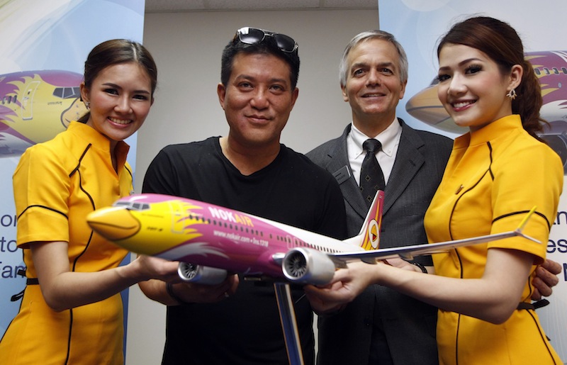 Thai budget airlines Nok Air's Chief Executive Officer Patee Sarasin poses with Boeing's Senior Vice President of Global Sales of Commercial Airplanes John Wojick after an announcement of new orders at the Singapore Airshow