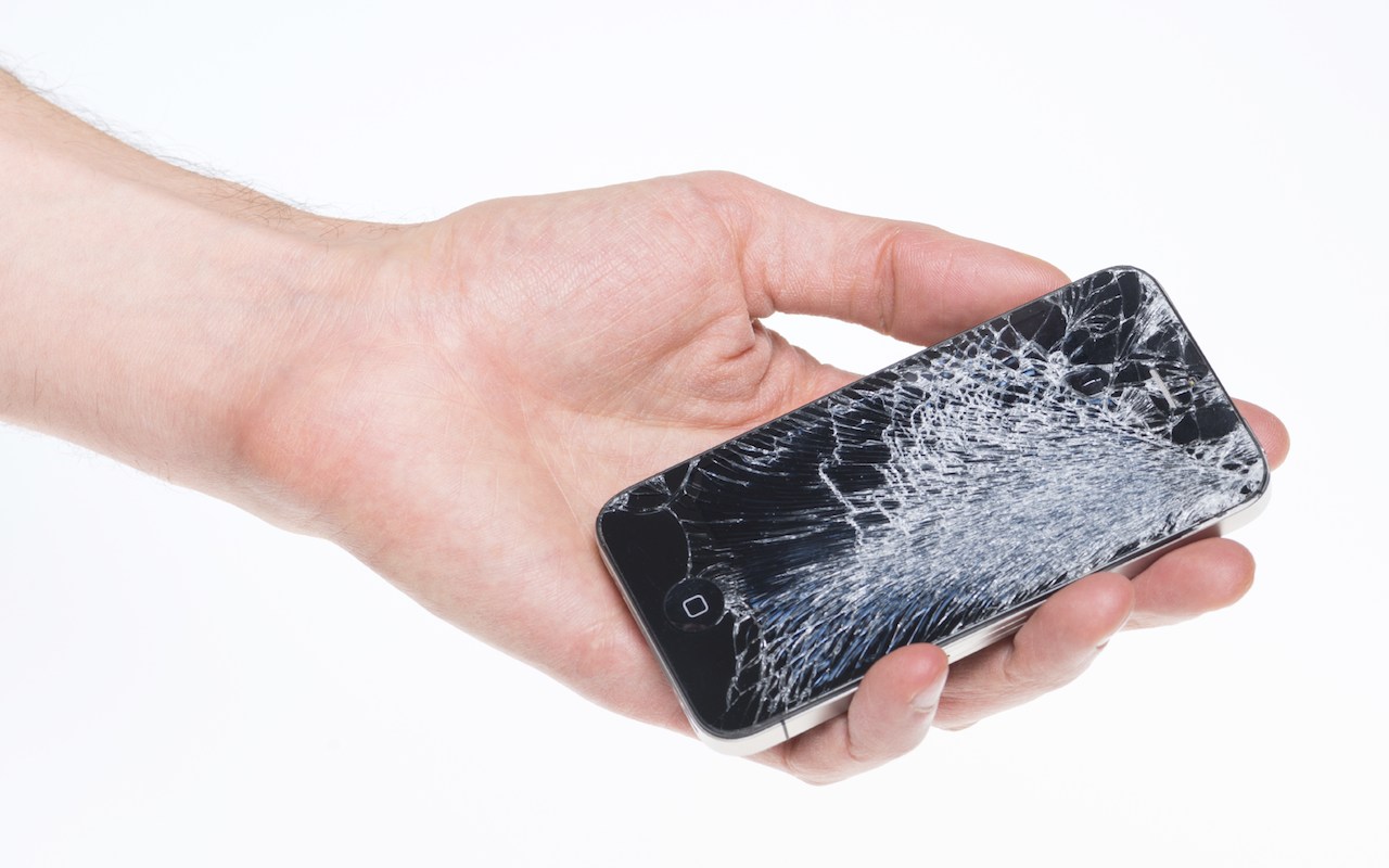 Broken Apple iPhone 4 in hand